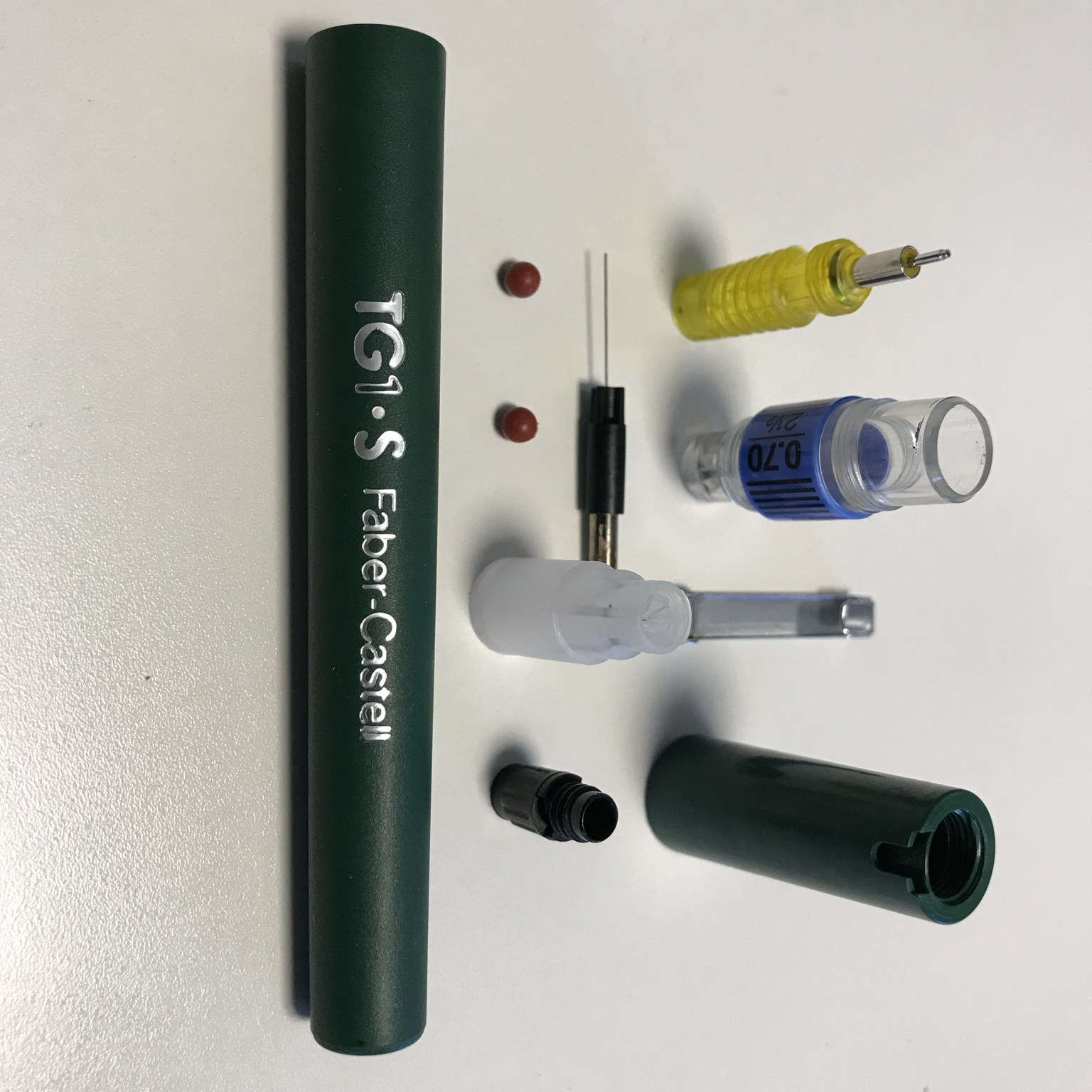 Disassembled Faber-Castell TG1-S technical drawing pen parts